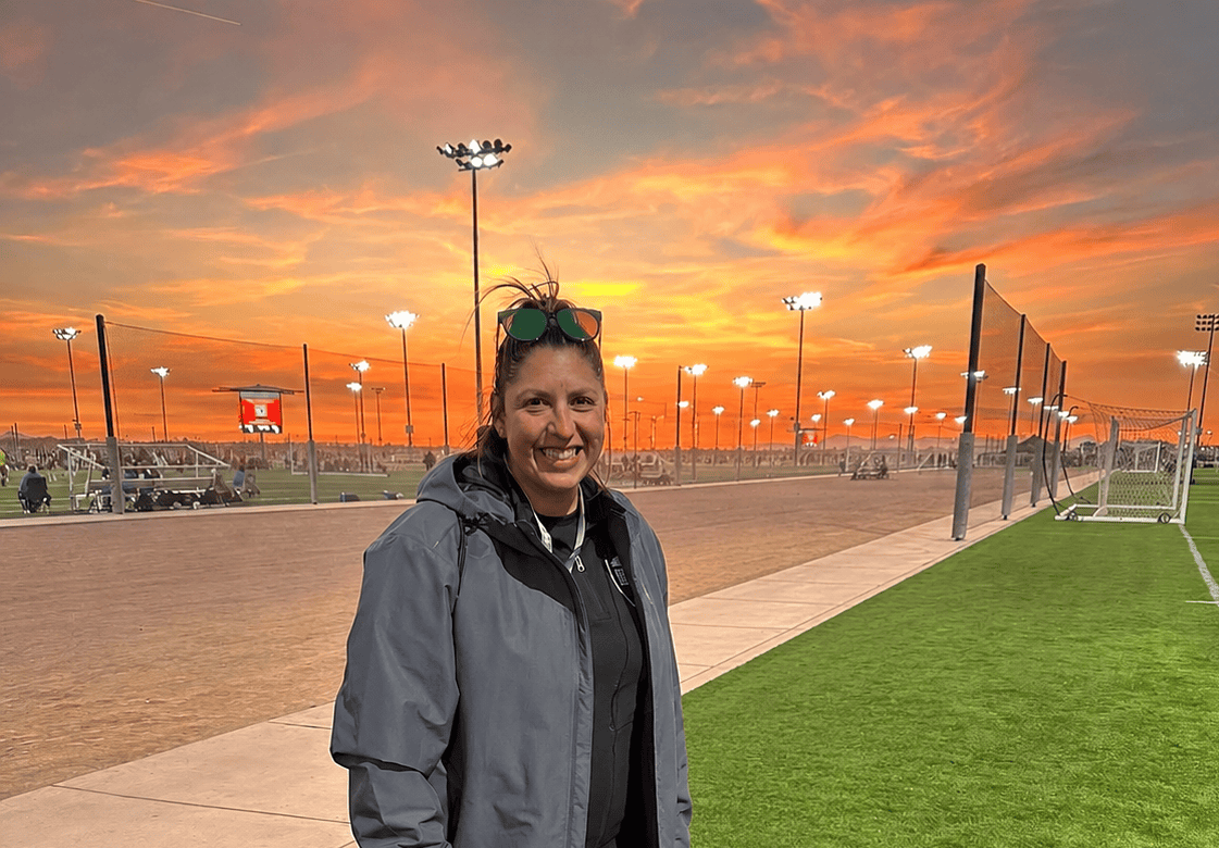 Coach Savanna at a soccer complex at sunset